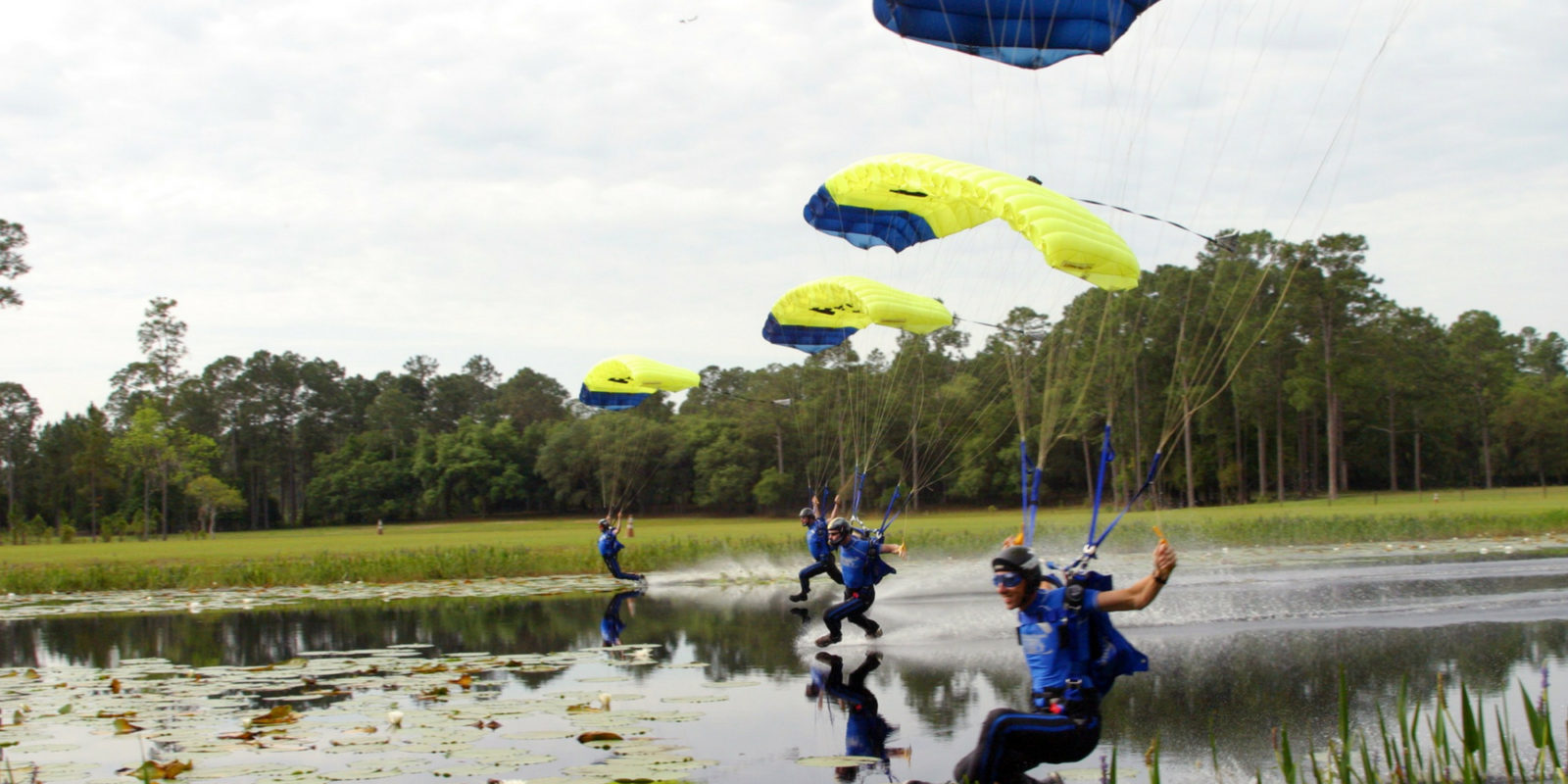 Shannon Pilcher dips toe in the water as he swoops over a lake with lilypads