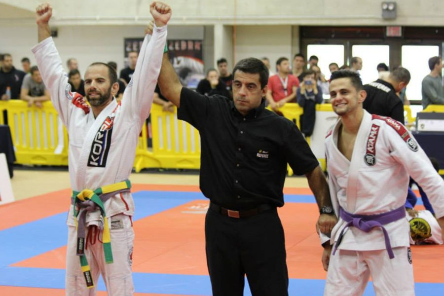 Referee lifts Chris Cyr's hands in victory after match