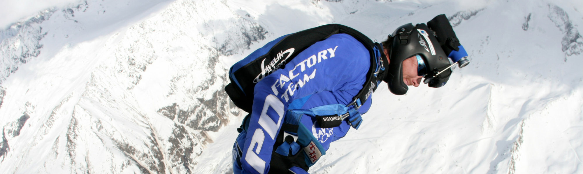 Shannon Pilcher skydiving above snowing mountains