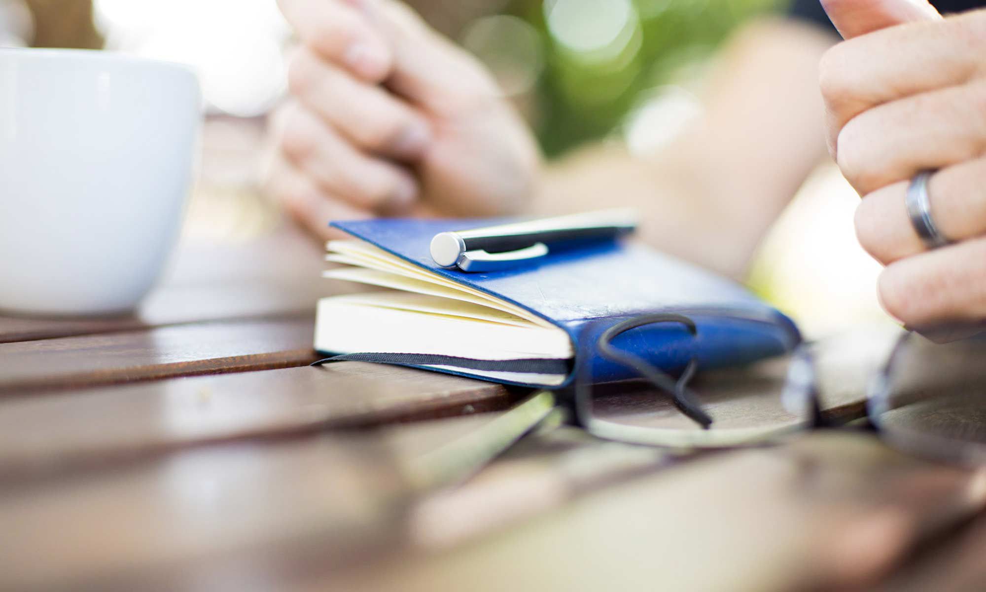 Shannon Pilcher's hands and blue journal