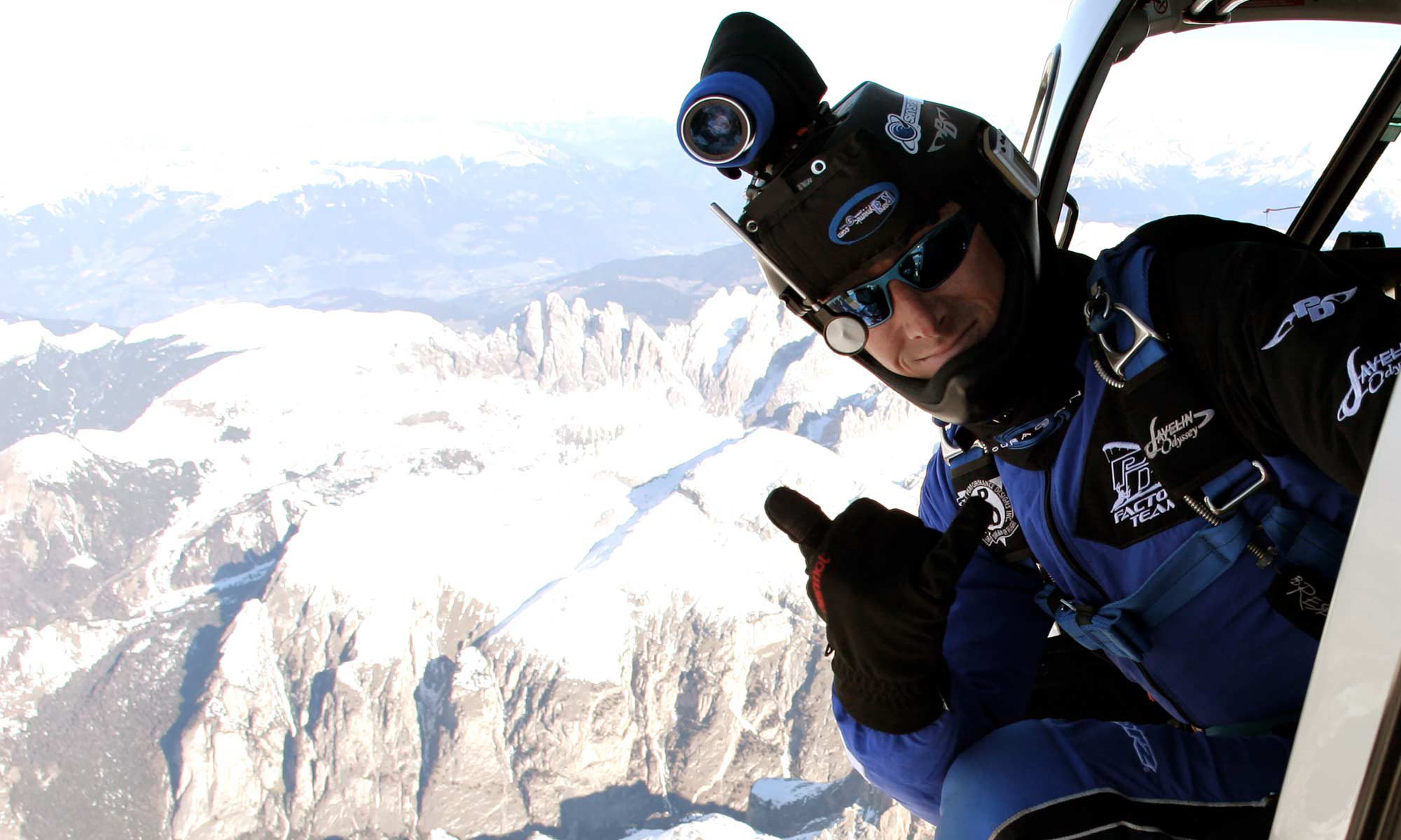 Shannon Pilcher gives thumbs up before exiting to skydive over snowy mountains