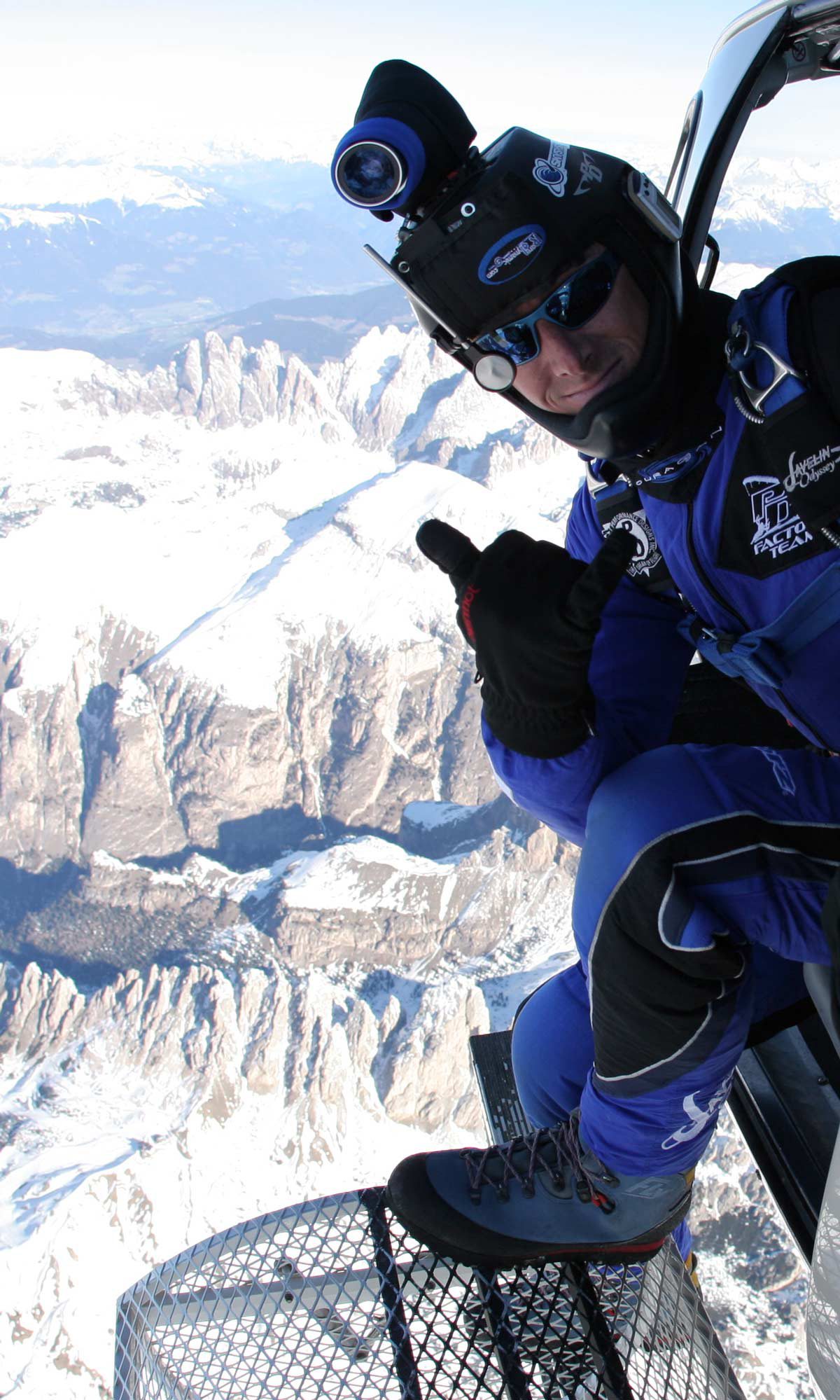 Shannon Pilcher gives thumbs up before exiting to skydive over snowy mountains